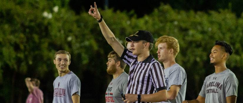 Student referee declaring second down during a flag football game.