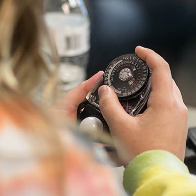 A student holding a measuring instrument.