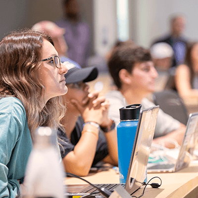 A student paying attention to a lecture in class.