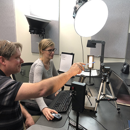 Instructor in studio getting help with recording 