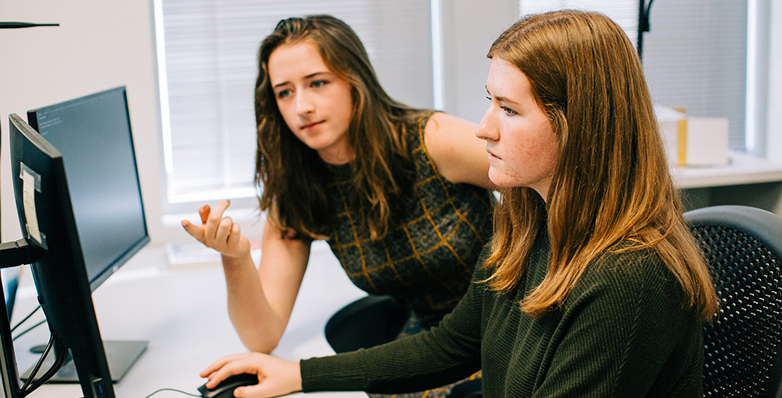 The McBride sisters working together on a computer.