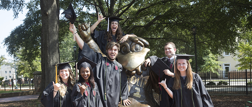 graduates at Cocky statue