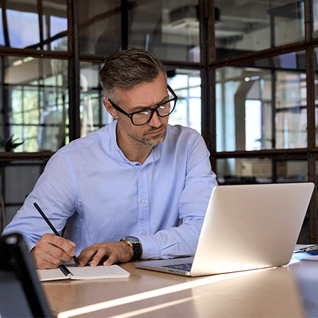 Man researches at computer at desk