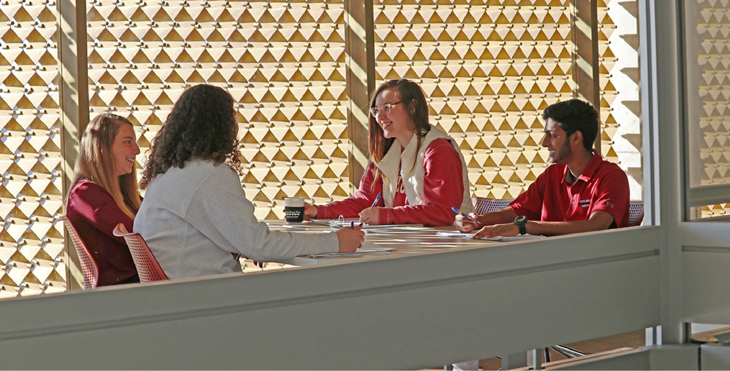 students studying at table in library