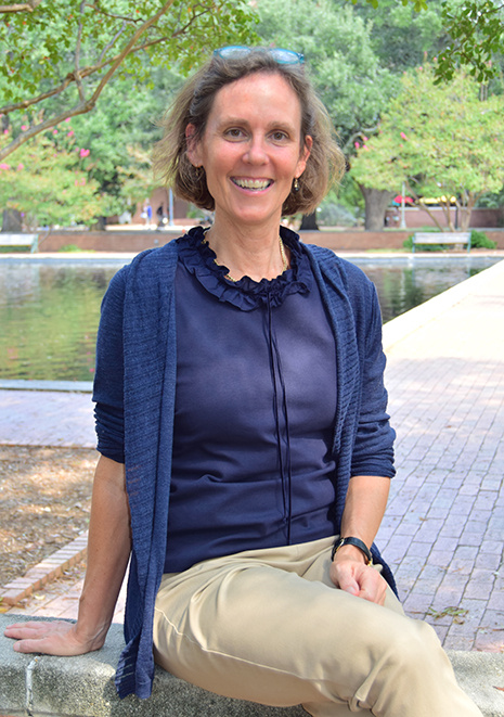 Digital Research Services librarian Kate Boyd sitting outside Thomas Cooper Library by the fountain