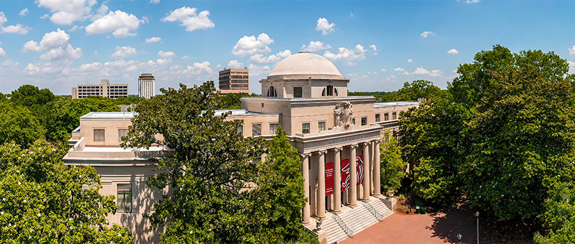 Areal view of McKissick Museum surrounded by the historic trees of the horseshoe and Capstone House and buildings in the background.