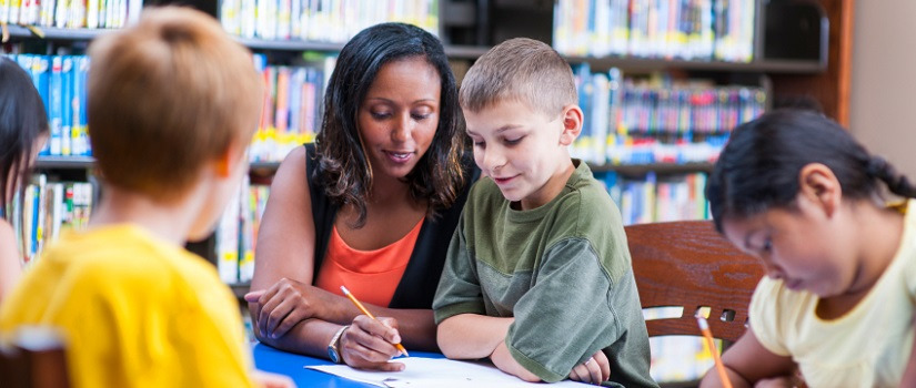 Teacher helps tutor a student