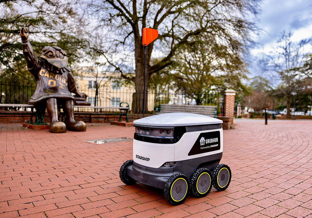 Starship delivery robot in front of Cocky statue on Greene St.