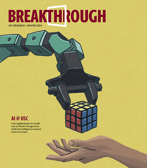 Cover of Breakthrough magazine with an illustration of robotic arm placing a Rubik's Cube into a human hand.. 