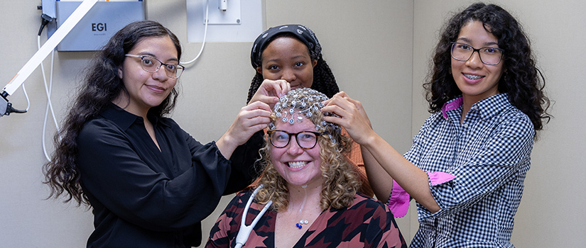 cap being placed on a woman's head during research