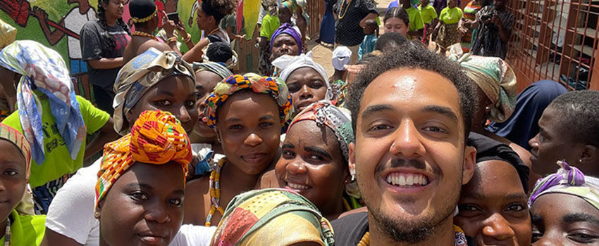 student smiling with a group of people