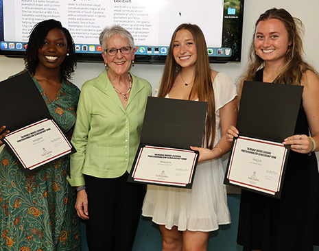 Janet Tarbox and girls holding awards