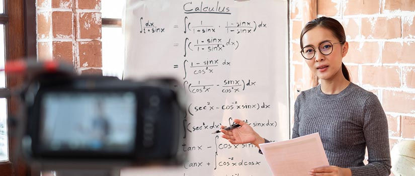 Math teacher teaching equations in front of a video camera