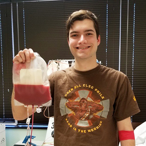 Mulliken holds up bag of stem cells