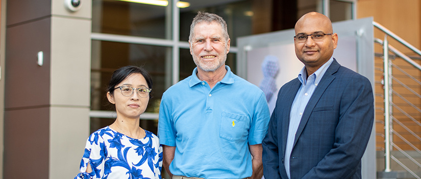 Yu, Giurgiutiu and Banerjee stand next to each other.