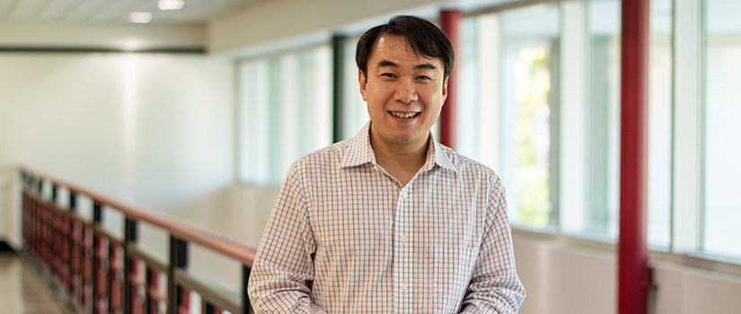 Nathan Huynh stands inside of the 300 Main building's lobby.