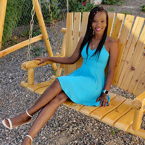 Tash Ulrich sitting on wooden swing