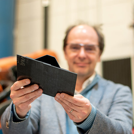 Dr. van Tooren holds up a composite material