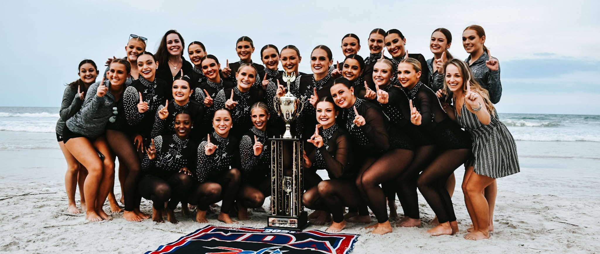 Carolina Girls together holding their trophy on the beach