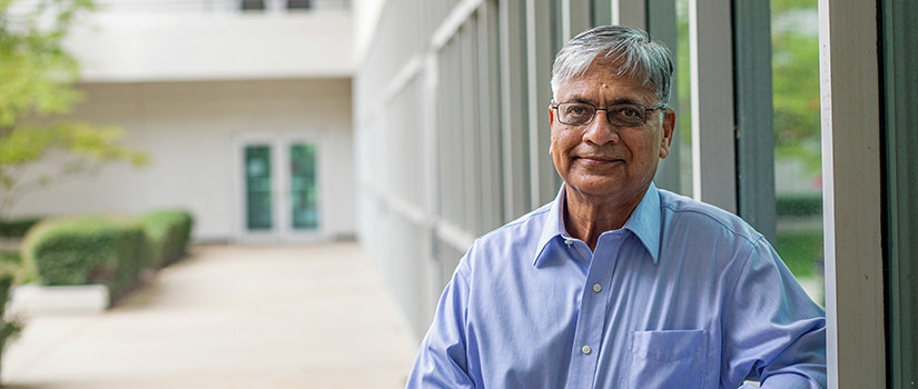 Asif Khan leans against the window in the Swearingen courtyard.