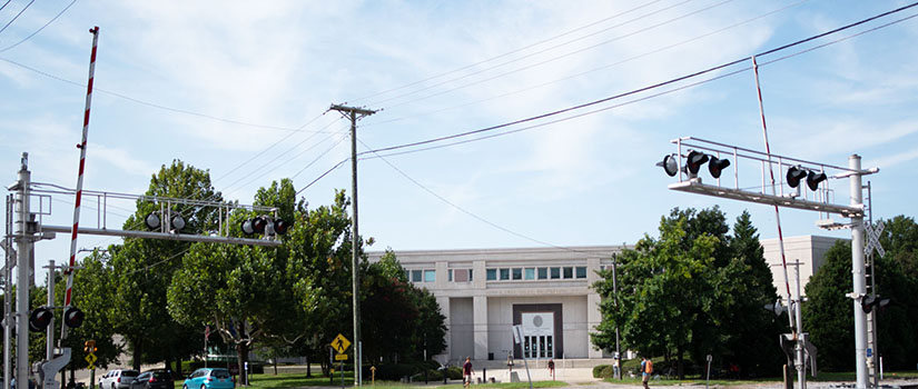 Main Street railroad crossing with entrance to Swearingen Building in the background.