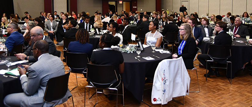 students sitting in ballroom at tables