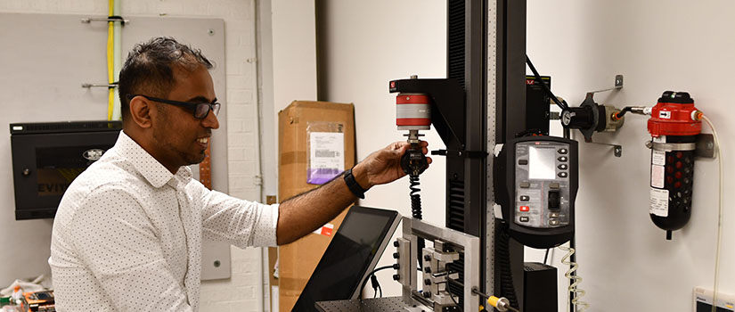 sockalingam working in a lab wearing safety goggles