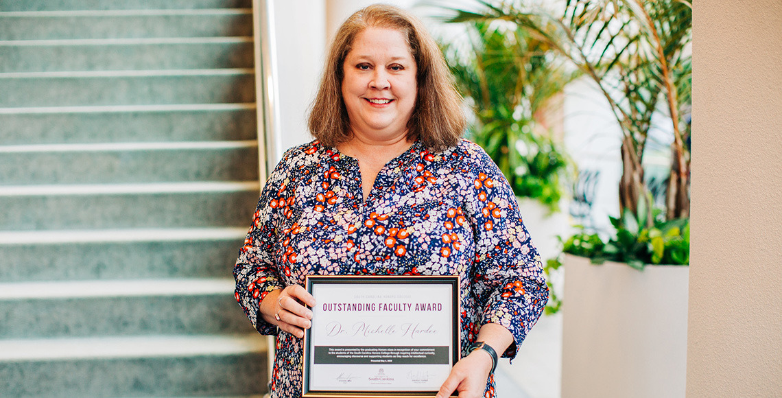 Michelle Hardee holding her award certificate