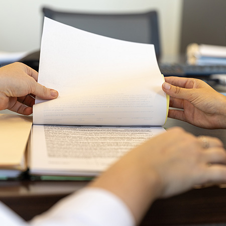 Image of two hands holding paperwork