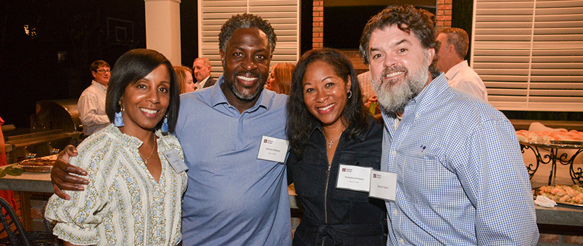 Alumni smiling at reunion