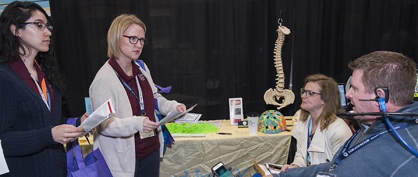 Exhibitor chatting with expo goers.