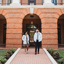 Students in White Coats leaving building 3