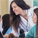 feamle instructor helping a female student in classroom setting