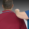 Woman assisting man with adaptive shirt