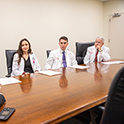 Students in a board room.