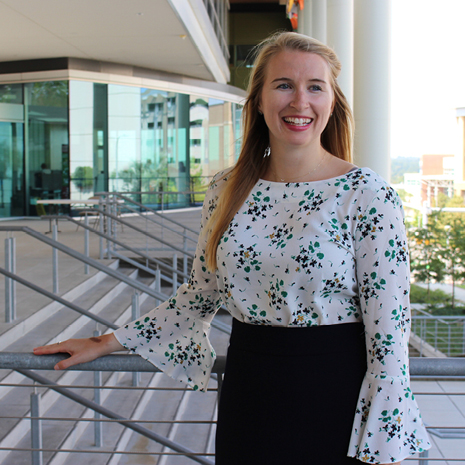 IMBA student Caroline Wright posing in front of the Moore School