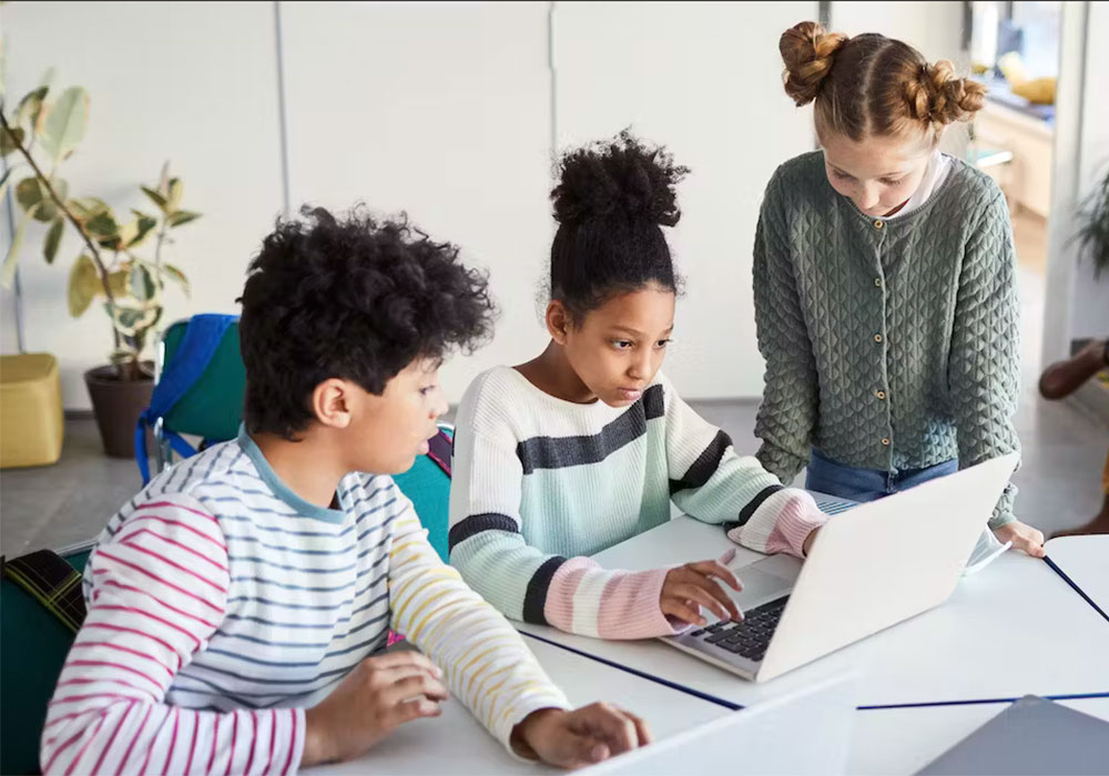 Three children looking at laptop