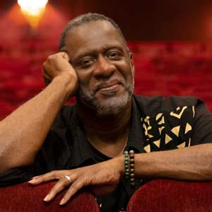 man sits in theater chair