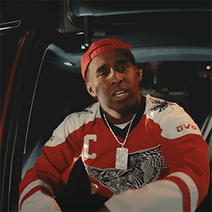 Man in a hockey jersey sits in a car