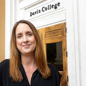 Jennifer Moore (woman) standing in front of Davis College