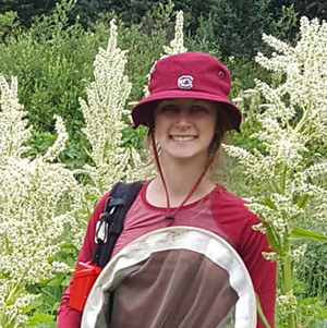 Hannah Walton in a field on a research study.